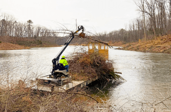 MTM grapple barge clearing brush and waterway debris
